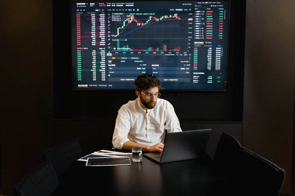 businessmanworkingonhislaptop7567556 币安App focused businessman analyzing stock market data on laptop with financial graphs displayed on screen 币安app